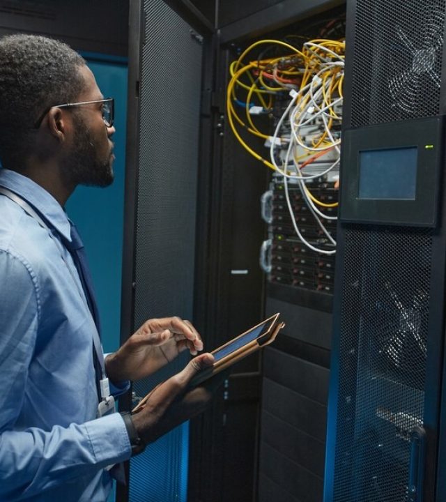 20230808130400_[fpdl.in]_side-view-portrait-african-american-man-standing-by-server-cabinet-while-working-with-supercomputer-data-center-holding-tablet-copy-space_236854-29025_large